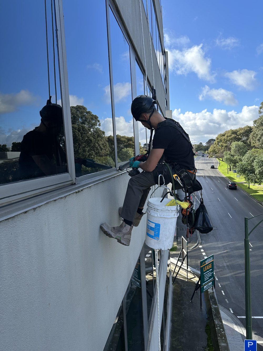 IRATA rope access technician working on a Melbourne building facade